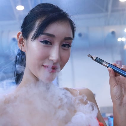 A model smokes an electronic cigarette during the Beijing International Vapor Distribution Alliance Expo. In a recent study, people who vaped showed more changes in the genes that fight off viruses than people who do not smoke. Photo: Getty Images