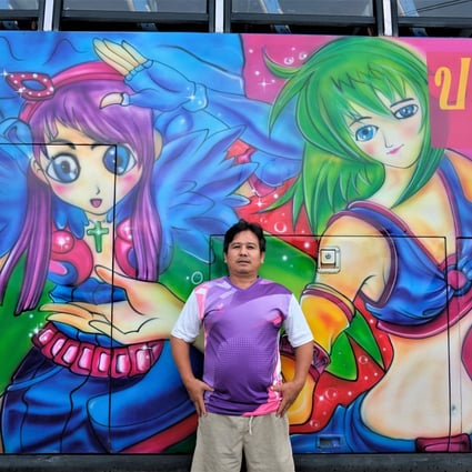 Tour bus driver Prapas Wongchua stands next to his coach decorated with giant anime characters in Nakhon Pathom province, near Bangkok, in Thailand. Photo: Tibor Krausz