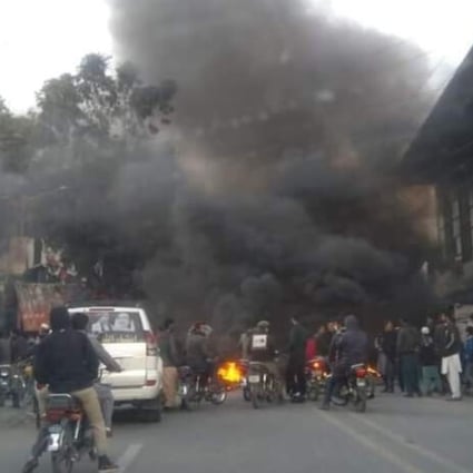 Protesters block a road with burning debris in Gilgit, capital of Pakistan’s Gilgit-Baltistan region, amid allegations of vote rigging in the recent legislative assembly elections. Photo: Tuyyab Babri