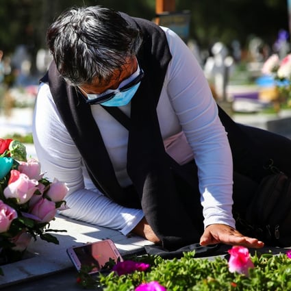 A woman in Mexico visits the grave of her mother, who died of Covid-19 at the age of 86. Photo: Reuters