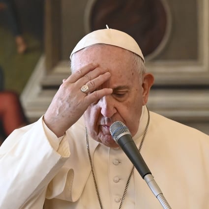 Pope Francis crosses himself during an audience from the library of the apostolic palace in The Vatican on Wednesday. Photo: Vatican Media handout via AFP