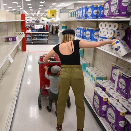 A shopper picks up a roll of toilet paper at a store in Burbank, California. Photo: AFP