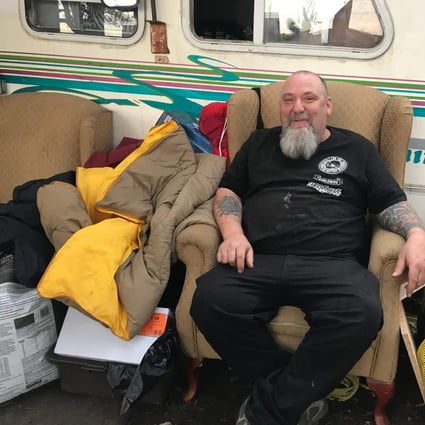 Homeless camp resident Guylain Levasseur poses outside his recreational vehicle at a camp set up along a busy Montreal boulevard. Photo: AFP
