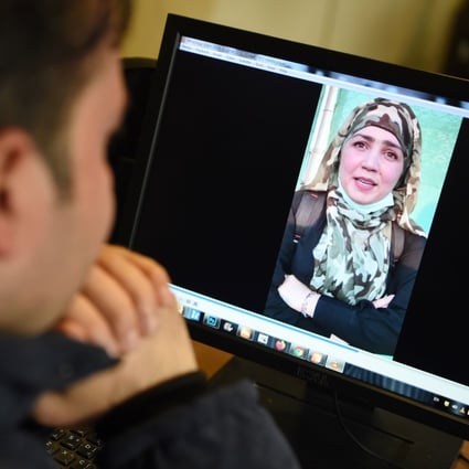 A man watches a video of Muzghan, who walked free from jail in September after confessing to being a member of the Taliban’s Haqqani network. Photo: AFP