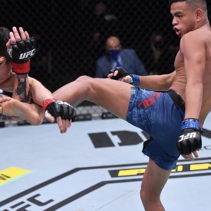 Brandon Royval kicks Brandon Moreno in their flyweight bout during UFC 255. Photos: Jeff Bottari/Zuffa LLC via Getty Images
