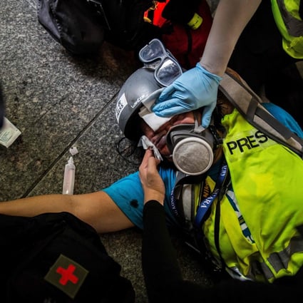 A member of the media receives medical help after being hit in the face with a projectile fired by police during clashes with protesters in Hong Kong on September 29 last year. The global environment for media has worsened. Photo: AFP