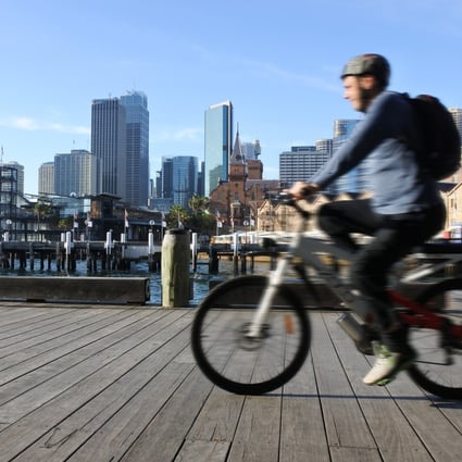 A man rides a bike along Circular Quay in Sydney in October 2016. The pandemic has hit cross-border investment in Australia’s commercial property market. Photo: Shutterstock