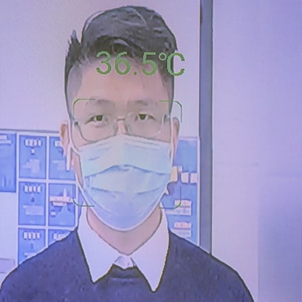 A man has his temperature measured at the entrance to an office building by an AI computer called ‘Smart AI Epidemic Prevention’ made by the company SenseTime, in Shenzhen, China in March 2020. Photo: EPA-EFE
