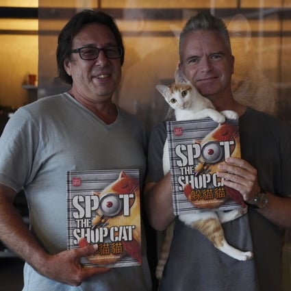 Hong Kong-based Australian illustrator Stephen Case (left) and Dutch photographer Marcel Heijnen show off their new book Spot the Shop Cat in Tsing Yi, Hong Kong. Photo: Winson Wong
