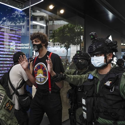 A men wearing a “Free Tibet” T-shirt is surrounded by police in Causeway Bay, Hong Kong, on China’s National Day on October 1. Photo: AP