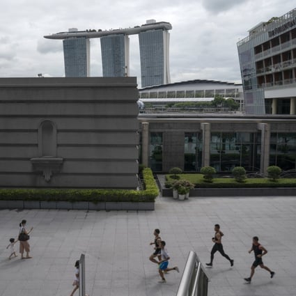 Joggers run by with the Marina Bay Sands Resort in the background in Singapore earlier this week. Photo: EPA