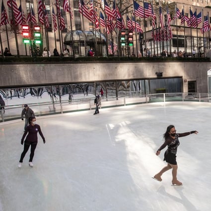 People wearing protective masks skate at Rockefeller Centre in New York City on Saturday as the spread of the Covid-19 continues, in New York City. Photo: Reuters
