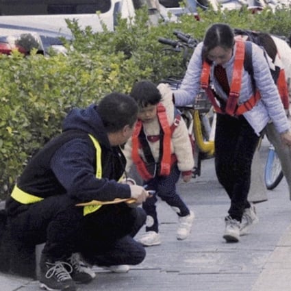 Artist Deng Yufeng (left) took a group of people down a street in Beijing, China, in an art piece that involved trying to not get caught on any surveillance camera. Photo: Deng Yufeng