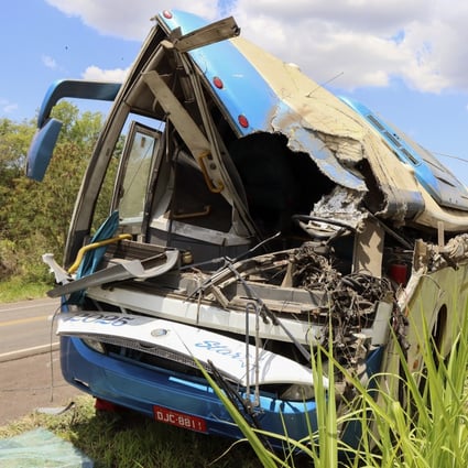 The wreckage of a bus that collided with a truck is seen by the road in Brazil on Wednesday. Photo: AP