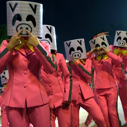 Performers in pig masks take part in the Lunar New Year night parade in Hong Kong last year. Photo: Reuters