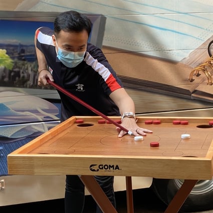 Marco Fu employs his snooker skills to play Chinese carom during a promotional event for the 2020 Hong Kong Festival of Sport. Photo: Chan Kin-wa