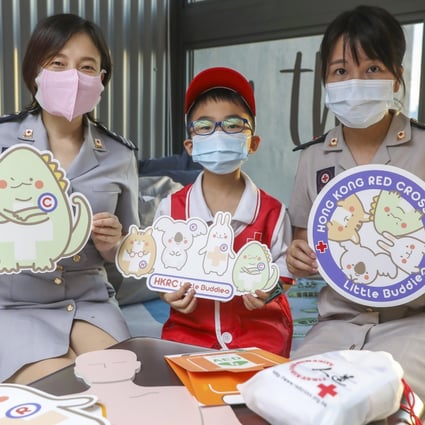 Hong Kong Red Cross staff officer Sandy Wong (left) and senior staff officer Heidy Lung (right) with student Jovon Lee, a member of the Red Cross Little Buddies programme in West Kowloon. Photo: K. Y. Cheng
