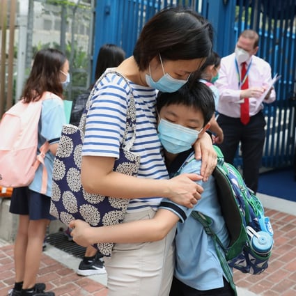 A mother hugs her son goodbye outside a school in Tai Kok Tsui on the first day back to school after coronavirus closures on May 29. Many Hong Kong parents are anxious about a suspension of face-to-face teaching once again now that the city has entered the fourth wave of Covid-19. Photo: Nora Tam