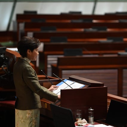 Chief Executive Carrie Lam gives her policy address on November 25 in front of the empty seats where the democrats once sat in the Legislative Council. Photo: AFP
