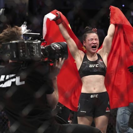 UFC women's strawweight champion Zhang Weili of China celebrates her split decision victory over former champion Joanna Jedrzejczyk of Poland during UFC 248 in Las Vegas. Photo: AP