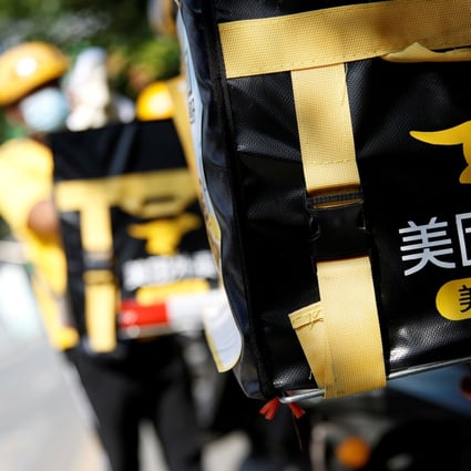 The logo of Meituan is seen on insulated boxes fastened on its food delivery couriers’ motorcycles in the central business district of Beijing. Photo: Reuters