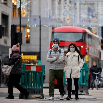 Pedestrians wearing face masks to combat the spread of the coronavirus, walk down Oxford Street in central London on November 27 as life under a second lockdown continues in England. Photo: AFP