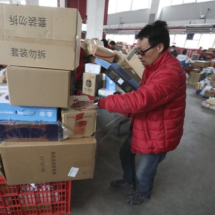 Workers sort out packages for delivery at JD's Yizhuang Smart Delivery Station in Beijing during Singles' Day shopping festival. Photo: Simon Song