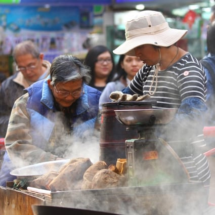 A Hong Kong hawker sells sweet potatoes, a popular snack in the city during winter. Photo: Shutterstock