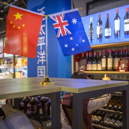 A visitor looks at a display of Australian wines at the China International Import Expo in Shanghai on November 5. China’s trade moves, such as raising import taxes on Australian wine, are hurting the Australian economy. Photo: AP