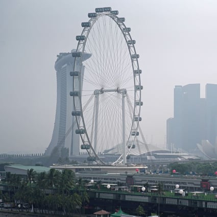 Haze shrouds the Singapore Flyer Ferris wheel in 2019 after wind from neighbouring Indonesia swept in ash and smoke from the illegal burning of forests and farmland. Photo: Bloomberg
