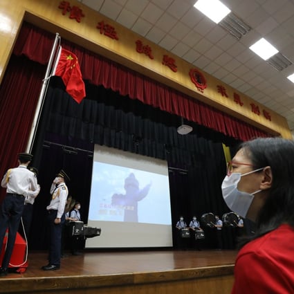 A flag-raising raising ceremony takes place at a secondary school in Ho Man Tin the day after the national security law was adopted. Photo: May Tse