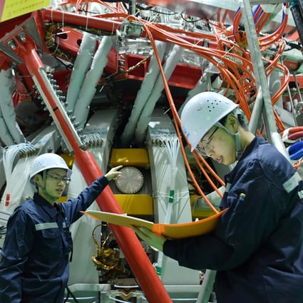 Technical personnel check China’s HL-2M nuclear fusion device at a research laboratory in Chengdu, Sichuan province on Friday. Photo: STR via AFP