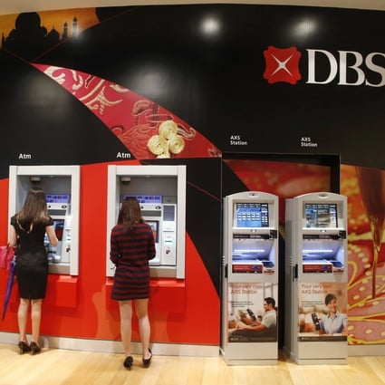 People access DBS cash withdrawal machines in Singapore. Photo: Reuters