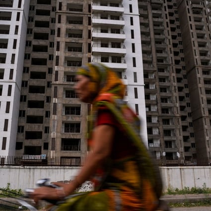 A cyclist rides past residential apartments under construction in Greater Noida, some 25km southeast of New Delhi, in 2017. India’s new Reit market facilitates tie-ups between liquidity-starved developers and risk-averse investors. Photo: AFP