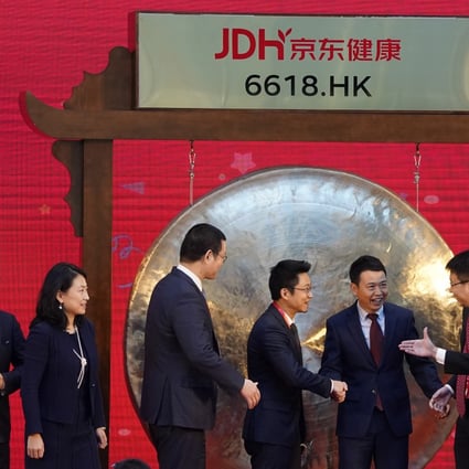 JD Health’s Xin Lijun, centre, during listing ceremony at headquarters in Beijing on December 8. Photo: AP