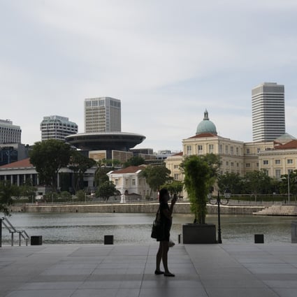 A view of the present (left) and past Supreme Court buildings from the Singapore River. Photo: Bloomberg