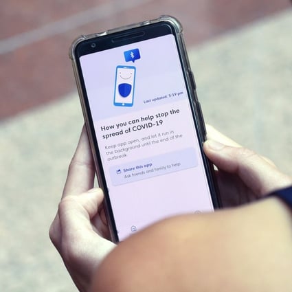 A Government Technology Agency (GovTech) staff member demonstrates Singapore's contact-tracing smartphone app, which was rolled out in March. Photo: AFP
