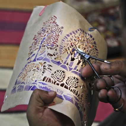 Ram Soni, a paper-cutting artist, works at his home in Alwar, Rajasthan, India. An Indian designer and architect couple launched a campaign called “Empowerment through Craft” to help traditional artisans restart sales and trade via an online platform. Photo: AP