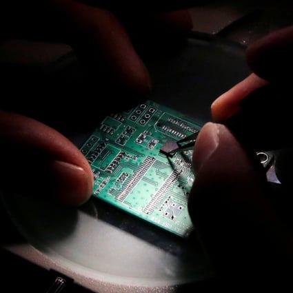 A researcher works on a semiconductor chip at Tsinghua Unigroup’s research centre, in Beijing, China, in February 2016. Photo: Reuters