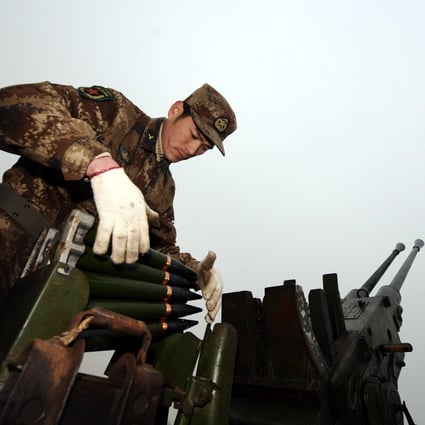 A Chinese soldier loads cloud-seeding shells during a weather modification mission in northern Shanxi province in February 2011. Photo: Xinhua