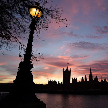 The sun sets behind the Palace of Westminster, comprising both houses of the British parliament, the House of Commons and the House of Lords, in central London. Photo: AFP