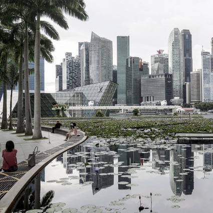 The skyline of Singapore’s financial district is reflected in a lotus pond at the ArtScience Museum on November 17. Singapore’s tightly held property market, where assets are rarely traded and office yields are already among the lowest in Asia, has pushed its real estate investors to look further afield. Photo: EPA-EFE