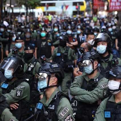 Police stand guard during a banned rally on National Day in Hong Kong. Photo: EPA-EFE