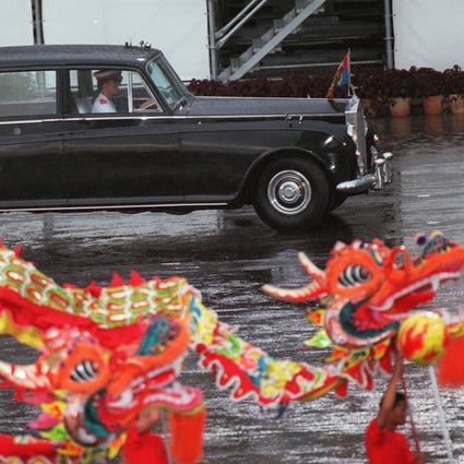 A dragon dance is performed as the official car for the departure of Hong Kong’s last governor Chris Patten and Britain’s Prince Charles passes by, following a farewell parade at the former HMS Tamar military base on June 30, 1997. The event marked an end to 156 years of British colonial rule in the city. Photo: AFP