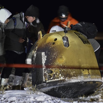 The recovery crew checks on the Chang’e 5 capsule after its return from the moon. Photo: Xinhua