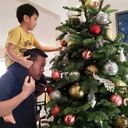 Satoru Mukogawa, executive chef of Sushi Kuu in Hong Kong, decorates a Christmas tree with his son. For many families in Japan, Christmas Day is “always KFC and a cake with a Santa Claus candle on top”, he says. Photo: Satoru Mukogawa