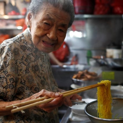 Hawker Leong Yuet Meng of Nam Seng Noodle House cooks at her shop in Singapore in February 2019. Photo: Reuters