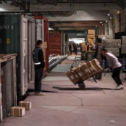 Workers pack containers in Yiwu, an inland port home to dozens of warehouses, where many exporters have recently seen their bank accounts frozen for weeks or months – often by police located in other Chinese provinces. Photo: Ren Wei