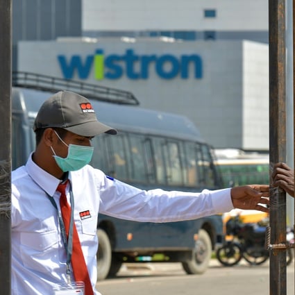 Private security personnel guard the entrance of a Taiwanese-run iPhone factory at Narsapura, about 60 km from Bangalore. Photo: AFP