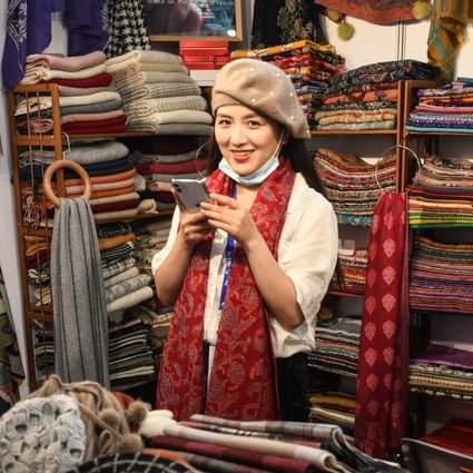 An exhibitor sells goods at the “Belt and Road” exhibition area of the 17th China-Asean Expo in Nanning, Guangxi, on November 27. The belt and road is an idea rather than a project, and lends its name to multiple projects and events, even theme songs, cartoons, courses and think tanks. Photo: Xinhua